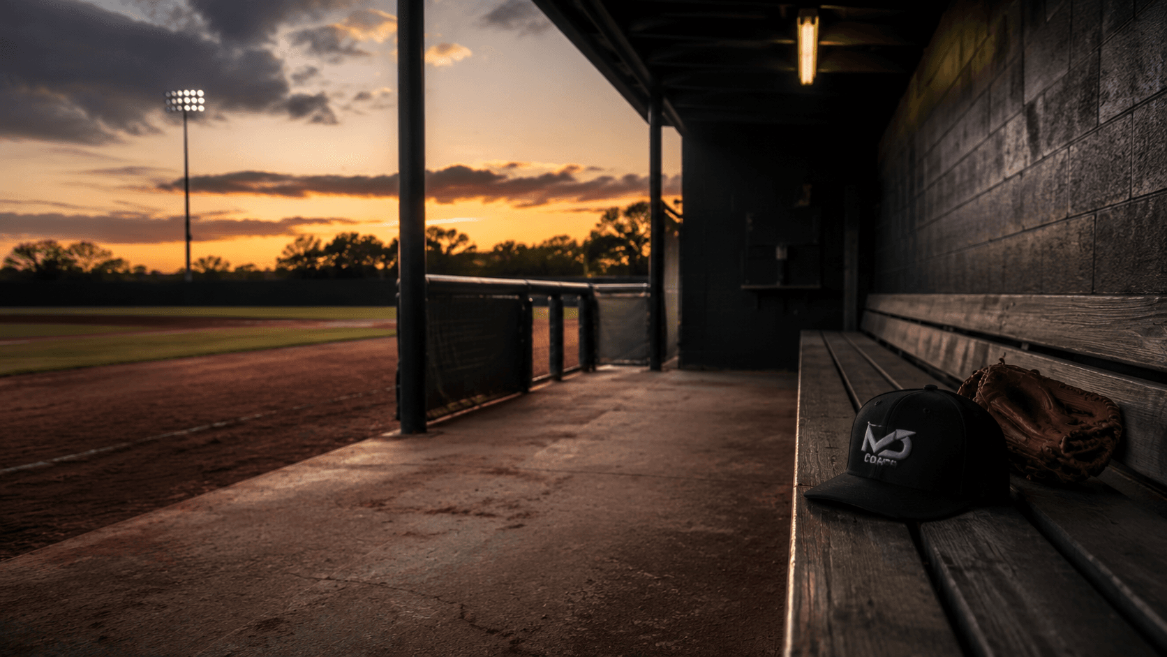 An empty baseball dugout at sunset with Modern Day Coach equipment.
